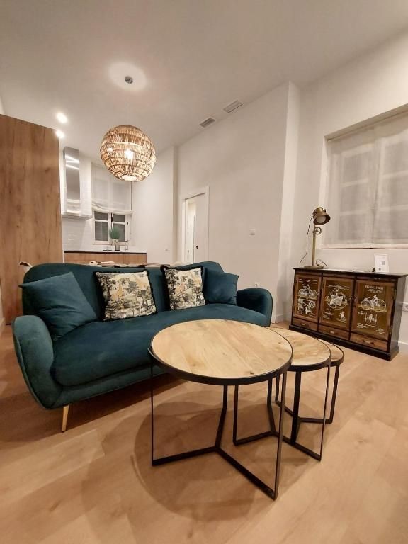 Captivating living room in Cadiz apartments, adorned with exquisite decor and bathed in natural light, showcasing the perfect blend of comfort and coastal elegance.